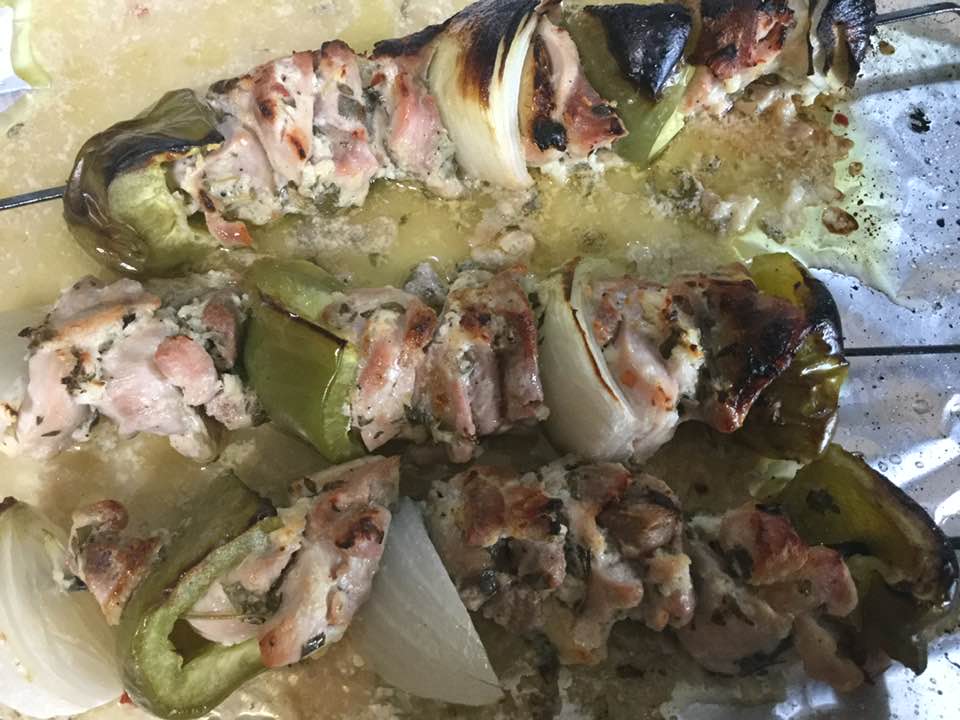 greek chicken kabobs on baking sheet